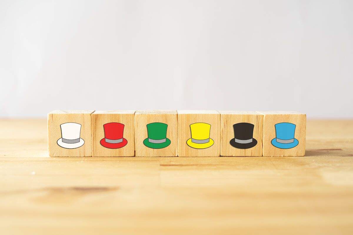 Wooden blocks with different colored hats drawn on it