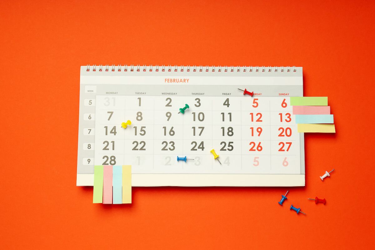 Calendar with post its and thumbtacks