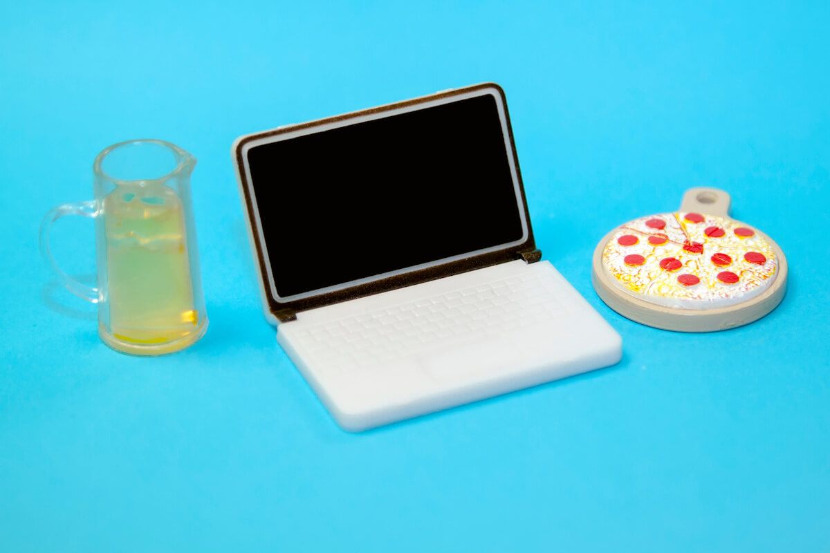 Toy laptop, pizza and a glass of beer
