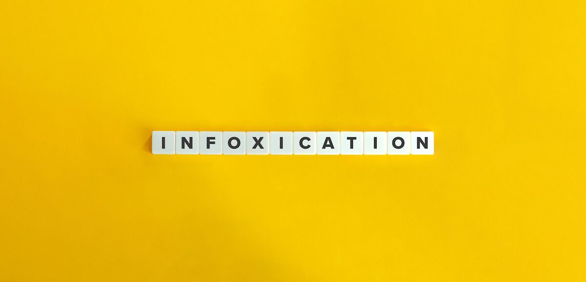 Information overload: INFOXICATION spelled using letter tiles