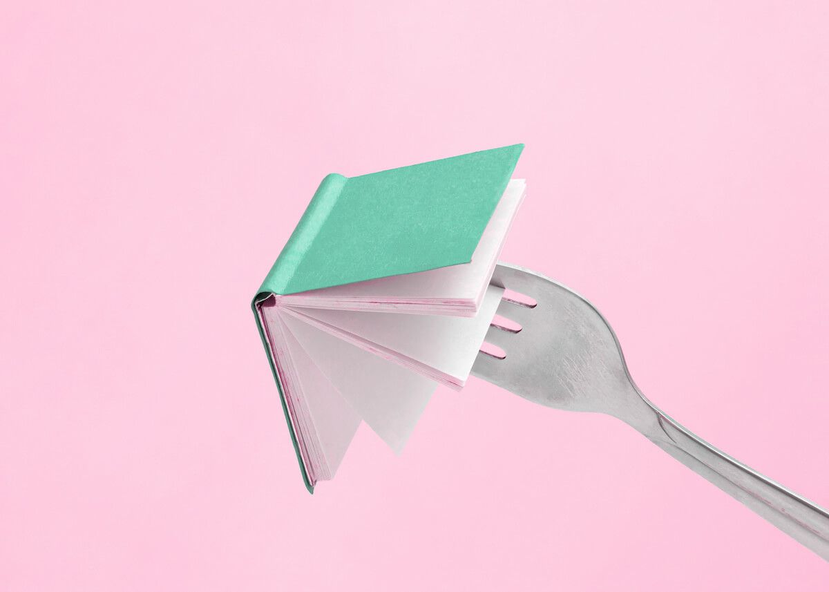 Fork stuck into a little book