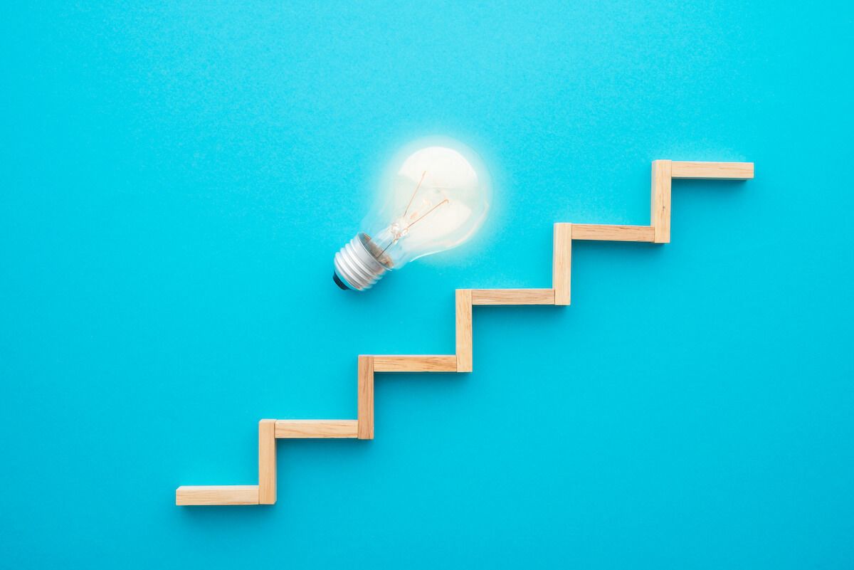 Wooden stairs and a light bulb