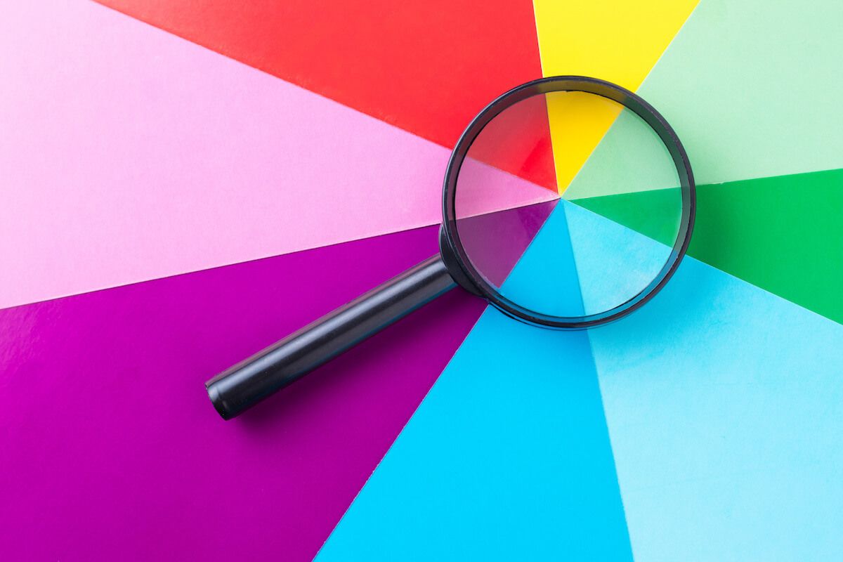 Magnifying glass on a multi-colored background
