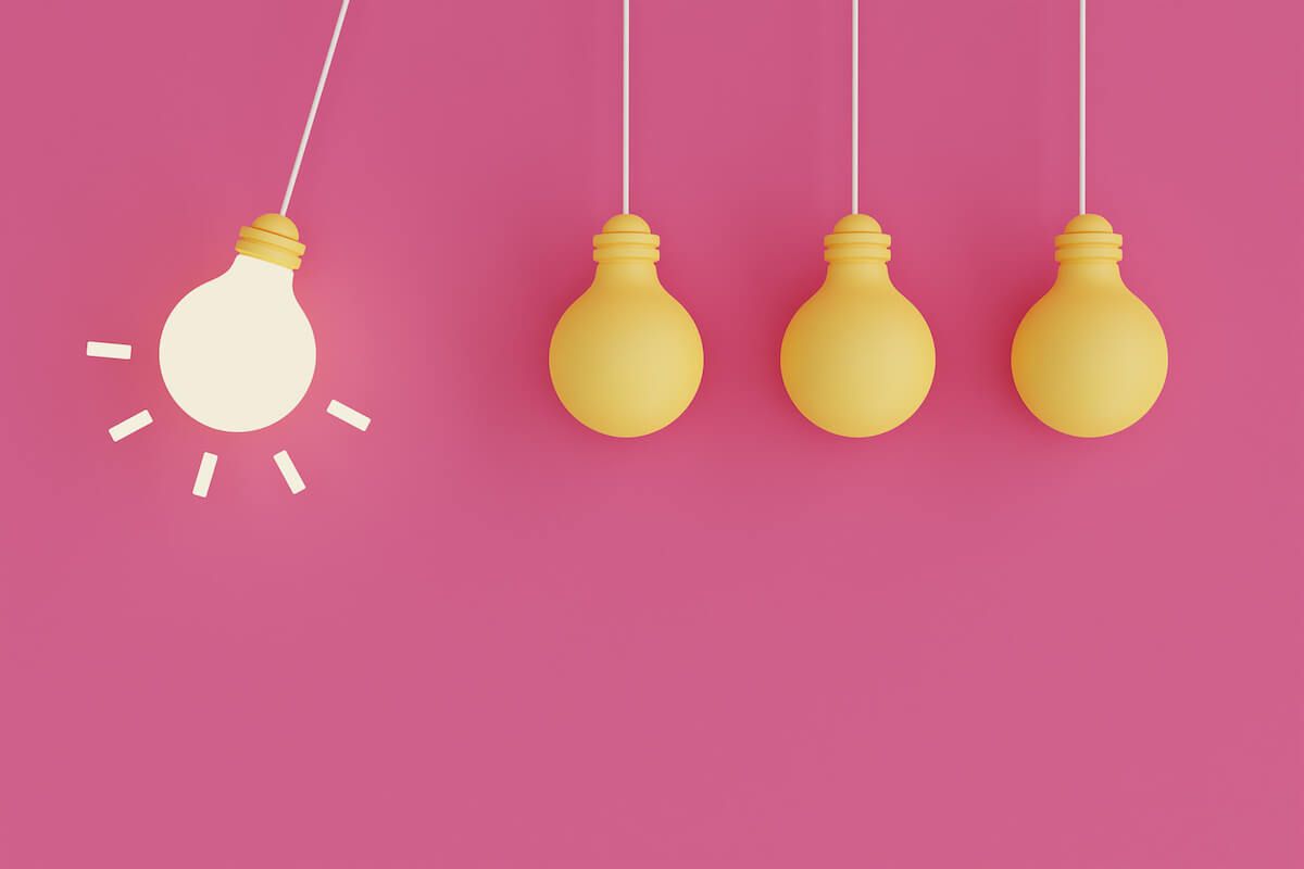 Hanging light bulbs on a pink background